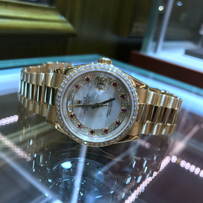 Rolex 劳力士 星期日历型系列，118348。36毫米表径，18K金壳金带，10颗红宝石刻度，镶钻白色贝母面盘，钻石表圈，自动上弦机械机芯。 全套附件齐全。